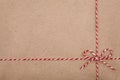 Christmas string or twine tied in a bow on kraft paper backdrop Royalty Free Stock Photo