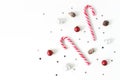 Christmas styled composition. Christmas red and white balls, baubles, candy canes, glittering silver stars confetti Royalty Free Stock Photo