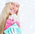 Christmas surprise and glitter snow background, happy blonde with gift boxes in winter season for shopping sale and