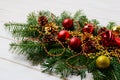 Christmas swag with red ornaments, golden beads and pine cones Royalty Free Stock Photo