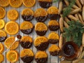 Christmas sweets, candied fruits in chocolate. Caramelized orange slices on a light paper background. Homemade dessert. Slices