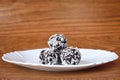 Christmas sweets on a plate - Rum balls in coconut. Traditional homemade handmade Czech sweets. Royalty Free Stock Photo