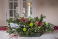 Christmas Table Arrangement or Centerpiece with flowers, evergreen branches