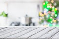 Christmas table background with christmas tree in kitchen out of focus. Background for display your products. Royalty Free Stock Photo