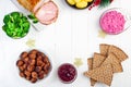 Christmas table with baked ham, beet salad, whole grane crackers, meatballs with lingonberry jam