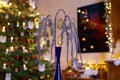 Christmas Table Decoration with hanging Glitter Branches in festively Decorated Family Room