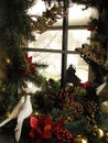 Christmas window decorations, believe, peace,  two doves, red poinsettia flower, pine cones Royalty Free Stock Photo