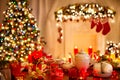 Christmas Table Dinner served, decorated with Xmas Ornament, Gifts. Fireplace and Christmas tree Light. Table setting for New Year Royalty Free Stock Photo