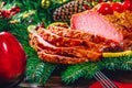 Christmas table dinner time with roasted meats, candles and New Year decor.