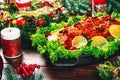 Christmas table dinner time with roasted meats decorated in Christmas style. Background thanksgiving. The concept of a family holi Royalty Free Stock Photo