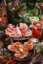 Christmas Table With Mini Canapes And Sliced Ham And Meats