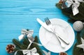 Christmas table place setting with blue and silver decoration on blue. Holidays background Royalty Free Stock Photo