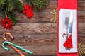 Christmas table place setting with fork and knife, decorated christmas toy - red fir-tree, christmas pine branches and Royalty Free Stock Photo