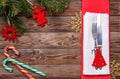 Christmas table place setting with fork and knife, decorated christmas toy - red fir-tree, christmas pine branches and Royalty Free Stock Photo