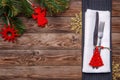 Christmas table place setting with fork and knife, decorated christmas toy - red fir-tree, gold snowflakes and christmas Royalty Free Stock Photo