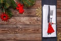 Christmas table place setting with fork and knife, decorated christmas toy - red fir-tree, gold snowflakes and christmas Royalty Free Stock Photo