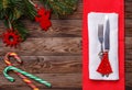 Christmas table place setting with fork and knife, decorated christmas toy - red fir-tree, two lollipop cane and Royalty Free Stock Photo