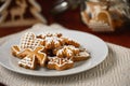 Christmas table with plate full of gingerbreads, homemade biscuits