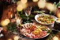 Christmas Table With A Platter Of Sliced Ham And Cured Meat And Salad