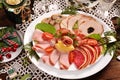 Christmas table with a platter of sliced ham and cured meat top view Royalty Free Stock Photo