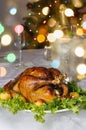 Christmas table with roast capon and bokeh in background