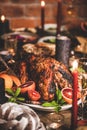 Christmas table with roasted turkey, chocolate cake and candles