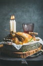 Christmas table set with roasted whole chicken, candles and wine Royalty Free Stock Photo