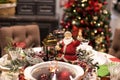 Christmas table seting with Santa and christmas tree behind Royalty Free Stock Photo