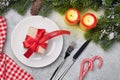 Christmas table setting with candles and xmas gift Royalty Free Stock Photo