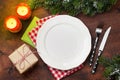 Christmas table setting with candles and xmas gift Royalty Free Stock Photo
