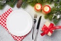 Christmas table setting with candles and xmas gift Royalty Free Stock Photo