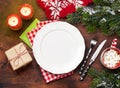 Christmas table setting with candles and xmas gift Royalty Free Stock Photo