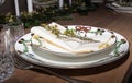 Christmas table setting with christmas decorations. Christmas plate on a wooden table.