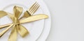 Christmas table setting close up view. Golden cutlery and decoration on white dishes Royalty Free Stock Photo