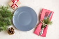 Christmas table setting with gift grey plate on white table. Xmas concept top view