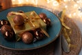Christmas table setting. Golden decoration with gift box, glass baubles and defocused lights. Christmas and New Year holidays Royalty Free Stock Photo