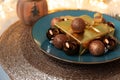 Christmas table setting. Golden decoration with gift box, glass baubles and defocused lights. Christmas and New Year holidays Royalty Free Stock Photo