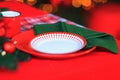 Christmas Table Setting. Holiday Decorations. Decor. Festive Christmas table decorations. Plate with napkin and tablecloth served Royalty Free Stock Photo