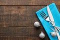 Christmas table setting. Knife and fork with blue napkin. on a brown wooden table. top view with space for an inscription. new Yea Royalty Free Stock Photo