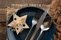 Christmas table setting. Knife, fork, spoon and plate with New Year`s scenery. on a brown wooden table. view from above . new Yea Royalty Free Stock Photo