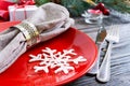 Christmas table setting. Plate, fork, knife, candle, napkin, gifts branch of a Christmas tree Royalty Free Stock Photo