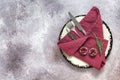 Christmas table setting. Plate, napkin, cutlery and a branch of fir on a beige grunge background. Top view, flat lay, copy space Royalty Free Stock Photo