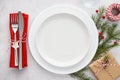 Christmas table setting with plates, red napkin, fork and knife Royalty Free Stock Photo