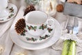 Christmas table setting with porcelain tableware with traditional decor