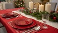 A christmas table setting with red plates and silverware created with technology Royalty Free Stock Photo