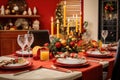 Christmas table setting with red tablecloth, candles and christmas decorations Royalty Free Stock Photo