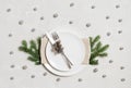 Christmas table setting with silver cutlery and decor on gray background. View from above Royalty Free Stock Photo