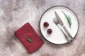 Christmas table setting. White plate, cutlery and napkin on rustic background. Top view, flat lay, copy space Royalty Free Stock Photo