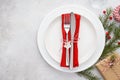 Christmas table setting with plates, red napkin, fork and knife Royalty Free Stock Photo