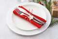 Christmas table setting with plates, red napkin, fork and knife Royalty Free Stock Photo